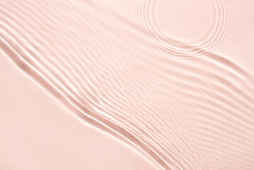 The texture of water on a pink background.