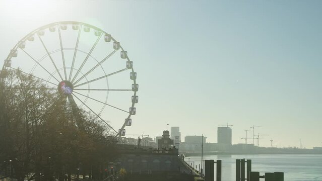 Antwerp morning light with river harbor and Ferris wheel slow motion