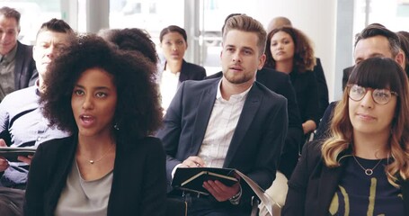 The life of a journalist. Businesspeople sitting in a convention center during a conference. Smiling businesspeople writing notes, talking during training workshop. Diverse businesspeople in workshop