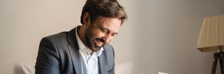 Obraz premium Smiling mid aged bearded man in formal wear