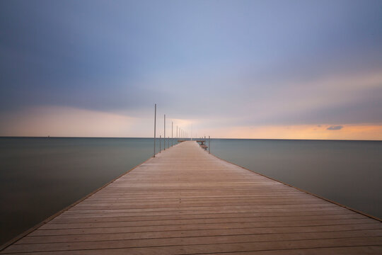Old jetty views during hazy sunset.