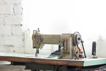 Old sewing machine on a table with a window in the background