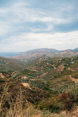 Fototapeta na wymiar Landscape overlooking mountains and hills, sea on the horizon, Crete, Greece.
