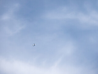 Airplane is flying in clear blue sky. Aircraft in flight in good weather. Minimalism.