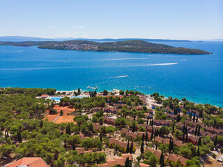 Croatia. Summer. Tourist season. Sunny day. Coast of the Adriatic Sea. Small town by the sea. Drone. Aerial view