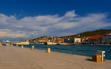 Fototapeta na wymiar Croatia. City of Trogir. Sunny day. Embankment street on the navigable canal