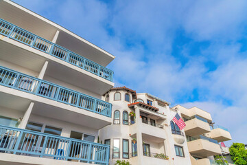 Three apartment buildings exterior with balconies in a low angle view at San Clemente, California