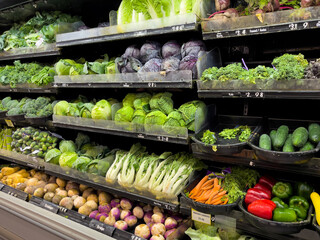 Fresh organic vegetable selection in produce aisle at grocery store supermarket.