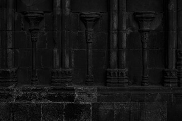 Fototapeta na wymiar Old black ancient wall. Dark background
