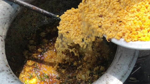 Mutton curry with channa dal mixing mega kitchen top view smooth motion 4k video clip.