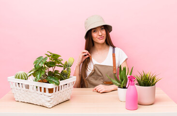 hispanic pretty woman looking arrogant, successful, positive and proud. plants and gardering concept