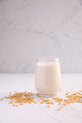 Soy milk in glass and soy bean isolated in white background