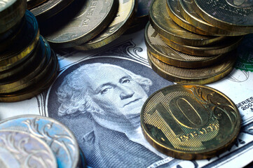 The American dollar on top of which lie Russian coins with a face value of 10 rubles. Translation...