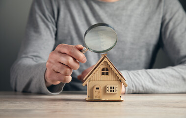 Fototapeta man hold magnifying glass looking house obraz