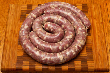 Raw sausages on a cutting board. Top view