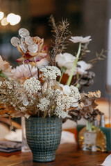 Wedding decor at the restaurant. Beautiful table setting with autumn flowers, orange and burning...