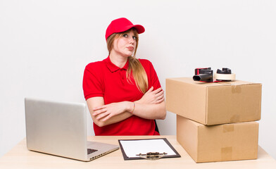 red head pretty woman shrugging, feeling confused and uncertain. employee concept