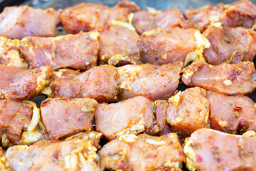 Raw marinated meat for kebabs on skewers