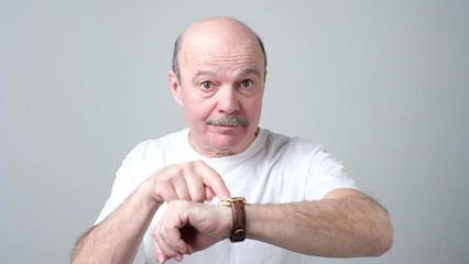 man showing time on his watch saying you are late