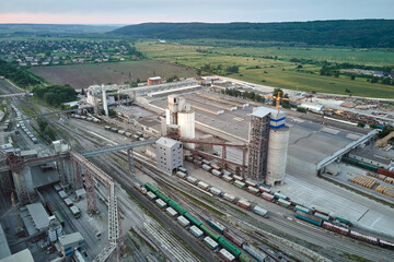 Aerial view of cargo train cars loaded with construction goods at mining factory. Railway transportation of industrial production raw materials