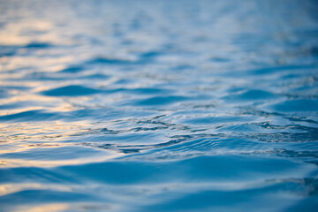 Closeup seascape surface of blue sea water with small ripple waves