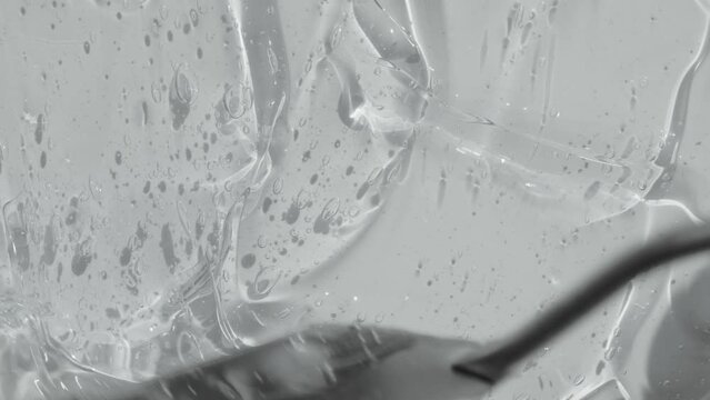 Transparent gel serum texture spreading footage. Hyaluronic acid with bubble. Liquid cosmetic skincare toner beauty product with peptide and collagen. Cleanser abstract background video 4k. 