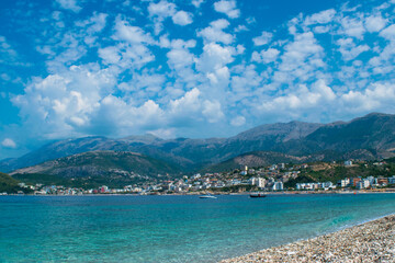 Beautiful summer cloud landscape of beach town of Himare. Adriatic sea. Albania. Concept of summer holidays and relaxation.