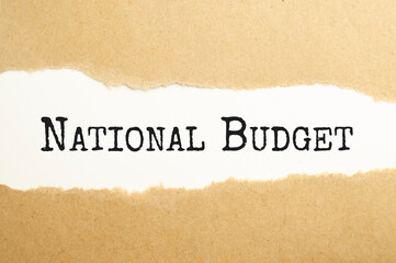 Fototapeta na wymiar National budget text on the brown torn paper
