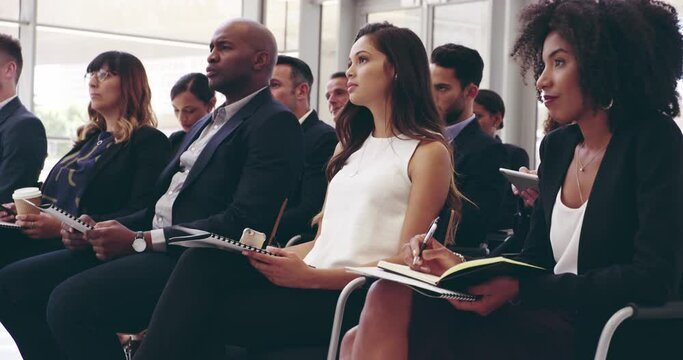 The whole conference has your attention. Group of diverse different aged confident, focused business people sitting in a conference room in a convention center to learn in a training workshop seminar