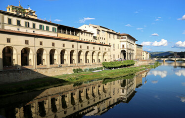 Fototapeta premium arcade with the reflection on the river Arno called CORRIDOIO VASARIANO in the city of Florence in the region of Tuscany in ITALY