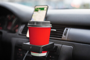 A cup of coffee in basket in the car