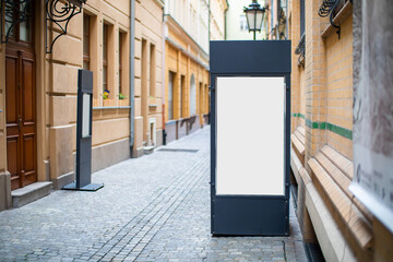 Blank street billboard poster stand mockup in old downtown.