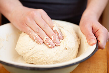 Kneading homemade yeast dough in a bowl. Sourdough bread.