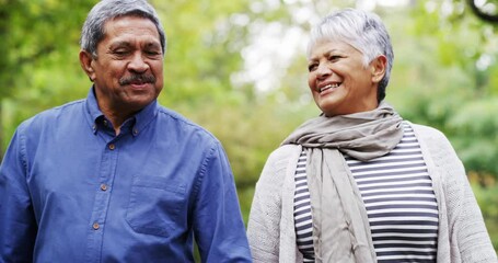 My heart is happy as long as Im holding your hand. 4k video footage of a mature couple out for a walk at the park.