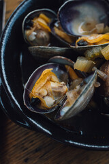 Pacific Northwest clams in broth in a bowl