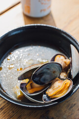 clams in broth in a bowl at outdoor restaurant
