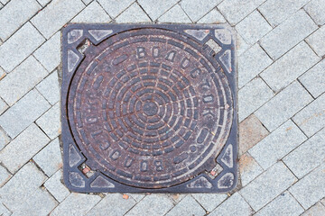 Old manhole cover in the street
