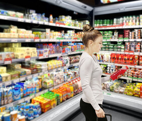 Woman choosing a dairy products at supermarket