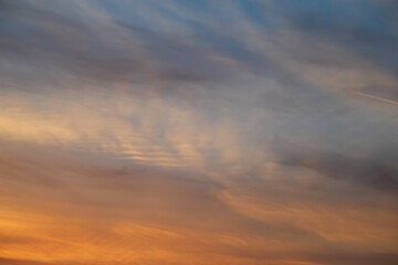 Sky background at sunset. Yellow clouds and blue sky