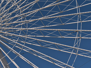 Close-up view of the white colored metal frame of a big Ferris wheel in theme park Wurstelprater in Vienna, Austria on sunny day in spring.