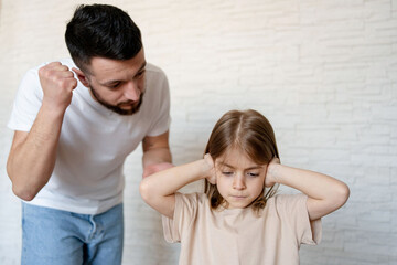 Upset kid girl closing ears not listening parent scolding at home, domestic violence, children and family problems concept
