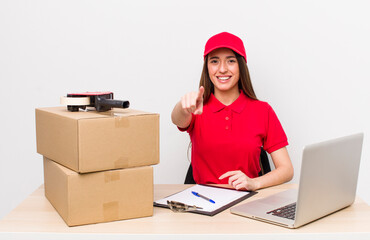 hispanic pretty woman pointing at camera choosing you. company employee concept