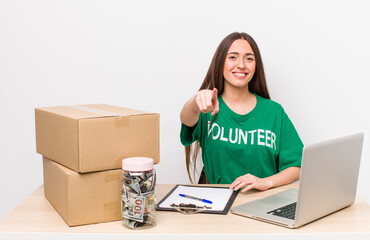 hispanic pretty woman pointing at camera choosing you. donations volunteer