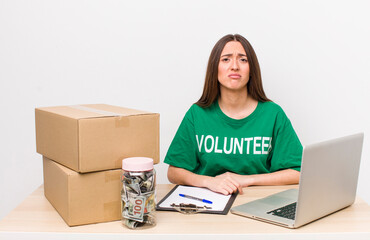 hispanic pretty woman feeling sad and whiney with an unhappy look and crying. donations volunteer