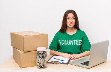 hispanic pretty woman looking puzzled and confused. donations volunteer