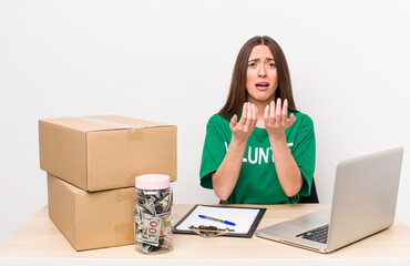 hispanic pretty woman looking desperate, frustrated and stressed. donations volunteer