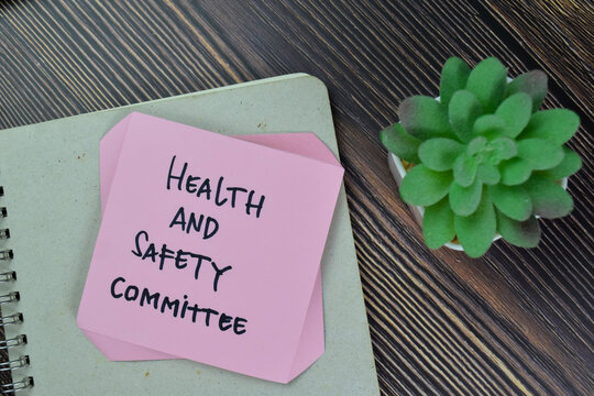 Health And Safety Committee Write On Sticky Notes Isolated On Wooden Table.