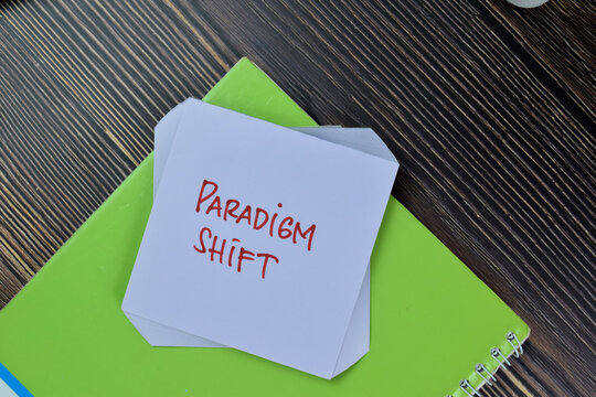 Paradigm Shift write on sticky notes isolated on Wooden Table.