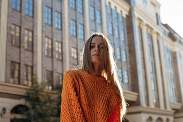 Close up portrait blond young beauty woman on the modern urban backgound. Female model posing and looking at camera.