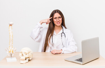 hispanic pretty woman feeling confused and puzzled, showing you are insane. spine specialist concept